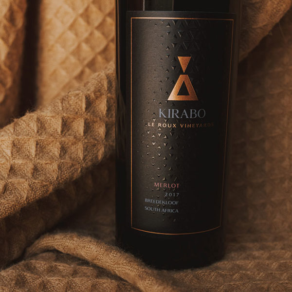 Focus on the label of Kirabo's 2017 Merlot. It is a textured black label with the logo in copper.