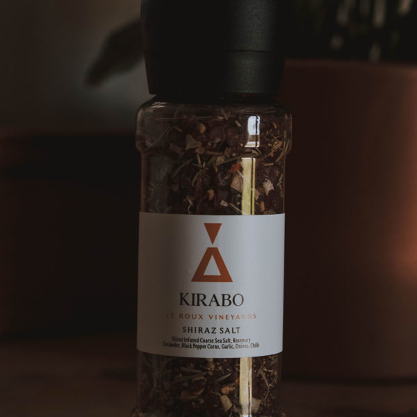 Kirabo's shiraz salt. White label with an orange copper triangle logo.