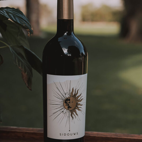 Sidouws red blend with a gold capsule, and gold sun on the label.